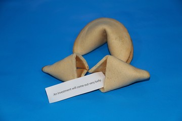 fortune cookies with a wisdom are lying in a blue studio