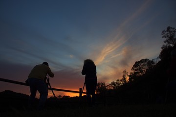 Fototapeta na wymiar silhouette of photographers at sunset