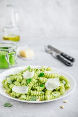 Fusilli pesto pasta with pine nuts, basil leaves and parmesan cheese