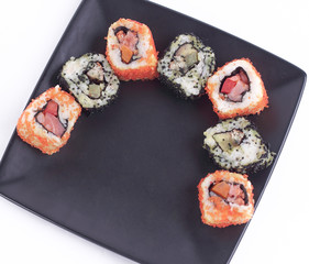 set of Sushi rolls on black plate