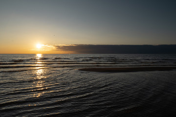 Obraz premium Vivid sunset with very low sun on the Baltic Sea - Red colors - Tuja, Latvia - April 13, 2019