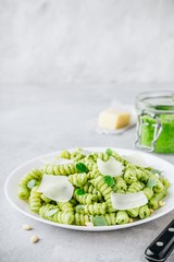 Fusilli pesto pasta with pine nuts, basil leaves and parmesan cheese