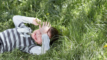 father plays with his little son on the grass in the Park