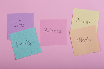 Choosing family or career concept - colorful sticky notes with words balance, work, career, family,...