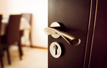 Open door to home. Door handle with lock