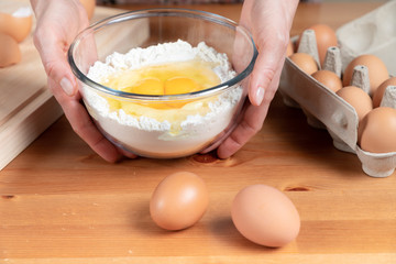 Young beautiful girl making dough