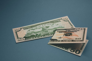 isolated american fifty dollar bill on blue background