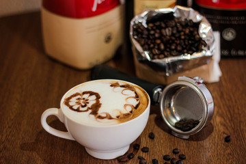 Coffee latte with beautiful design on top, coffee beans background