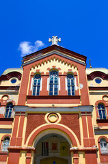 Fototapeta na wymiar Red Church in the blue sky