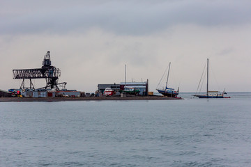 Fototapeta premium Distant view of Svalbard harbour on a cloudy autumn day in Arctic Ocean - Spitzbergen