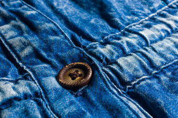 Blue washed faded jeans texture with seams, clasps, buttons and rivets
