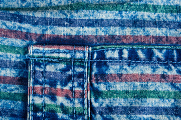 Blue washed faded jeans striped texture with seams, clasps, buttons and rivets