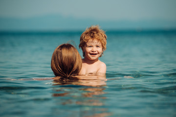 Summer happy family. Mother and son in the sea. Holidays. Vacation travel background. Hello, June.