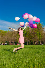 Woman balloons, full height, city park, jump