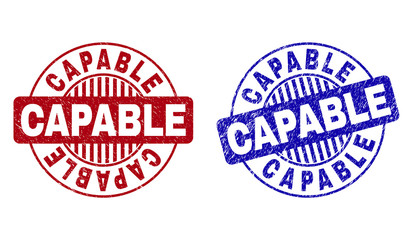 Grunge CAPABLE round stamp seals isolated on a white background. Round seals with grunge texture in red and blue colors. Vector rubber overlay of CAPABLE title inside circle form with stripes.