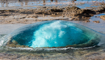 The turquoise blue boiling bubble of Strokkur Geyser before eruption. Gold Circle. Iceland.