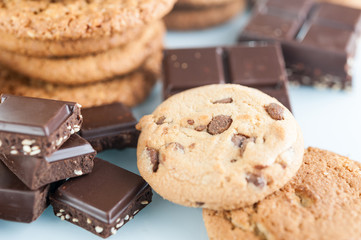 Various shortbread, oat cookies, chocolate chip biscuit and pieces of chocolate with seeds and nuts.