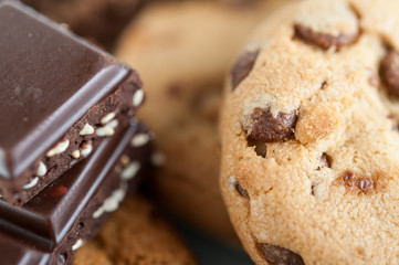 Various shortbread, oat cookies, chocolate chip biscuit and pieces of chocolate with seeds and nuts.