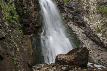 Naklejka na ściany i meble Closeup view of waterfall scenes in mountains, national park Dombay, Caucasus