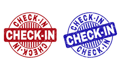 Grunge CHECK-IN round stamp seals isolated on a white background. Round seals with distress texture in red and blue colors. Vector rubber watermark of CHECK-IN tag inside circle form with stripes.