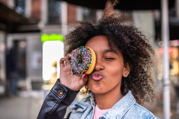 Cute Little Girl Eating a Donuts.