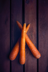 CARROTS ON DARK BACKGROUND WITH TEXTURE