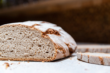  Close-up of slices of bread and bread on a blurred kitchen background.