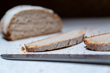  Close-up of slices of bread and bread on a blurred kitchen background.