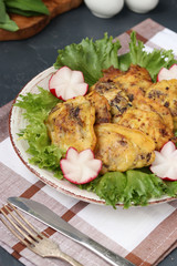 Chicken liver in batter is located on a plate on a dark background