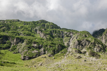 Fototapeta na wymiar Panorama of mountains on route of Trift Bridge in national park Switzerland