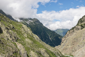 Fototapeta na wymiar Panorama of mountains on route of Trift Bridge in national park Switzerland