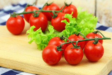 Juicy and ripe cherry tomatoes on vivid green lettuce leaves