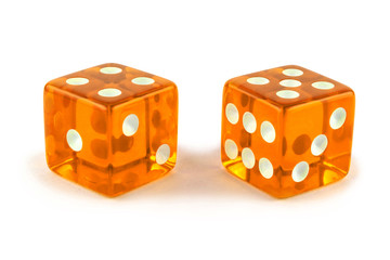 Two caramel color glass game dice very close up isolated on white background. Five and four.
