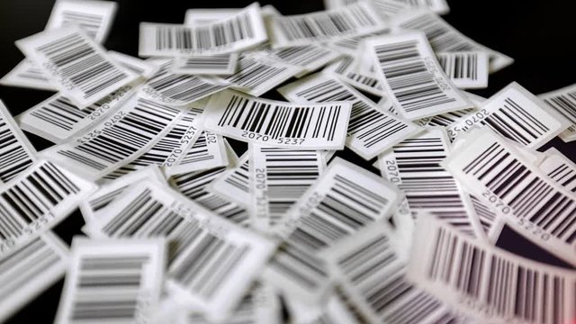 Red laser line is floating over printed barcodes stickers, line barcode reader over barcodes