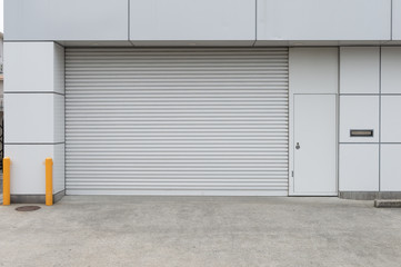 A closeup shot of automatic metal roller door used in factory, storage, garage, and industrial...