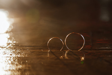 Abctract wedding rings in drops of water and lights