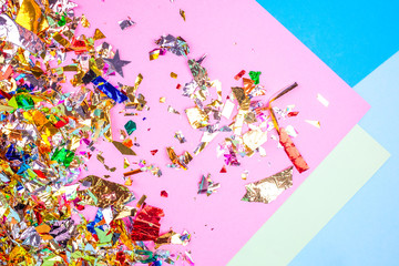 Colorful celebration background with confetti,stars, fireworks and decoration on pink background. Flat lay. 