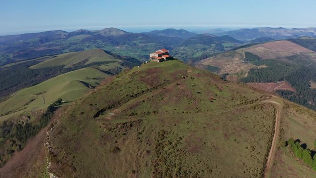 Hermitage in Kolitza peak in Balmaseda 285, Basque Country, Spain drone aerial footage - graded (ungraded version available)