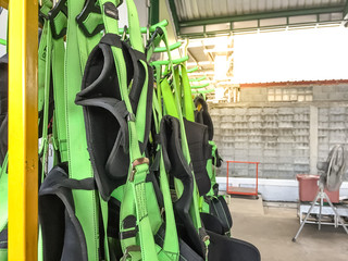 full body harness hanging on the rack,personal protective equipment for  height work