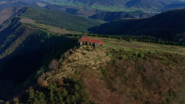 Hermitage in Kolitza peak in Balmaseda 299, Basque Country, Spain drone aerial footage - graded (ungraded version available)