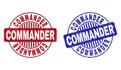 Grunge COMMANDER round stamp seals isolated on a white background. Round seals with grunge texture in red and blue colors. Vector rubber imitation of COMMANDER text inside circle form with stripes.