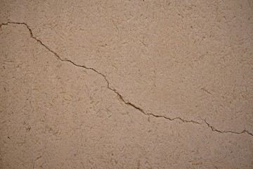 Dry cracking mud wall texture, natural background concept