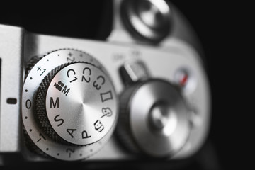 Modern digital mirrorless exposure controls on the top plate of the camera.