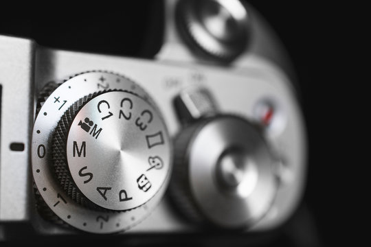 Modern digital mirrorless exposure controls on the top plate of the camera.