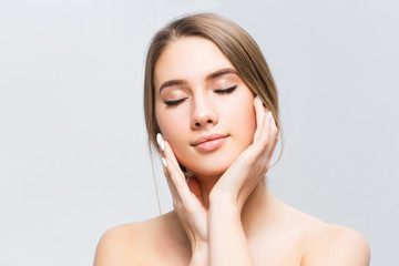 Beautiful face of young adult woman with clean fresh skin - isolated on white .