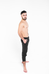 Fototapeta premium Bodybuilder posing. Handsome power athletic guy male. Young muscular man with hands on his pants,isolated on white. Lifestyle!