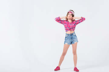 Portrait of attractive woman in pink beach hat ,summer clothes, posing while standing on  white background!