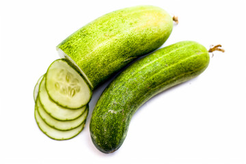 Raw cut sliced cucumber isolated on white.