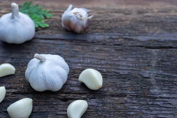 Top view of herbal vegetable ingredients, fresh garlic and red onion, on old wooden table, cooking preparation concept