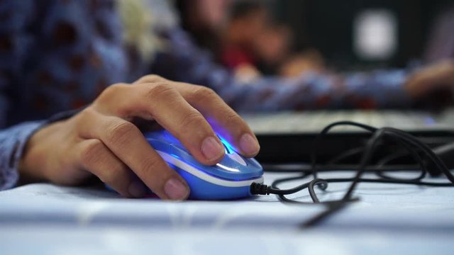 Gamer's Hands on mouse playing online e-sport gaming, Activity for new generation child always use time for video game that is either partially played through Internet, computer network available